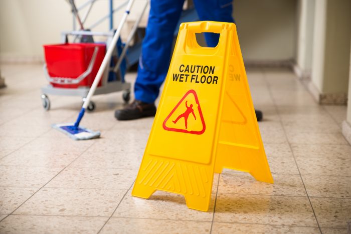 mop and bucket with wet floor sign