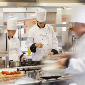 Male chef cooking in a restaurant kitchen having passed his Food Safety Level 2 course